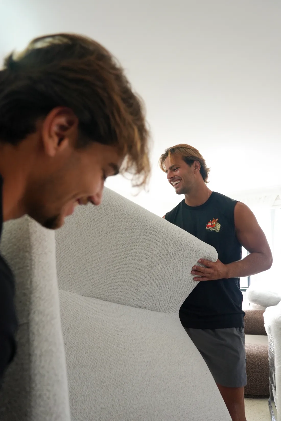 KangPack removalists carefully carrying a sofa during a Coogee move