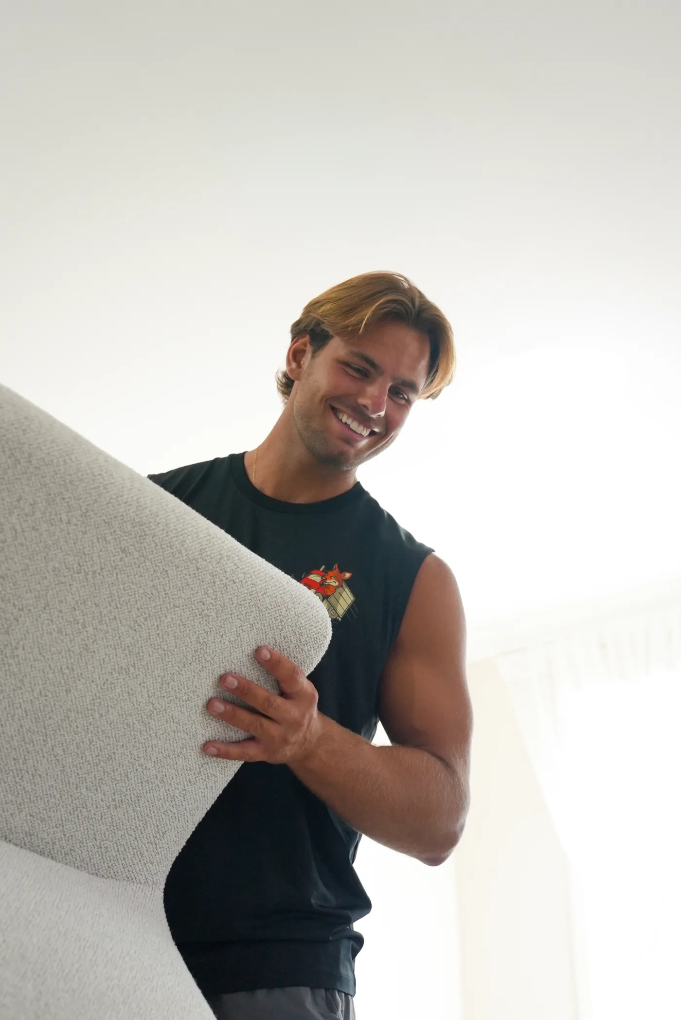 A KangPack removalist carrying an armchair during an indoor move